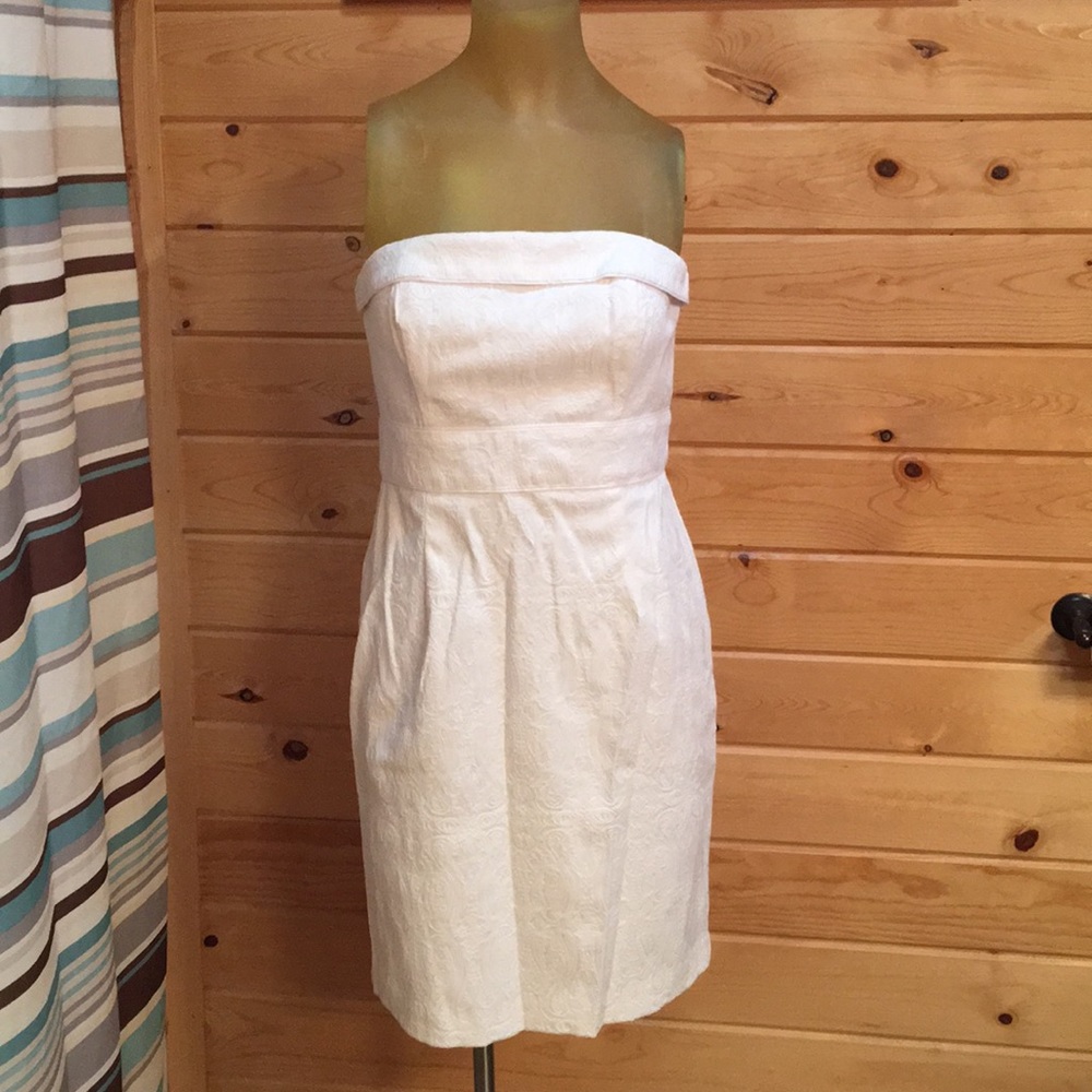 Fully lined white strapless dress. Size 4.